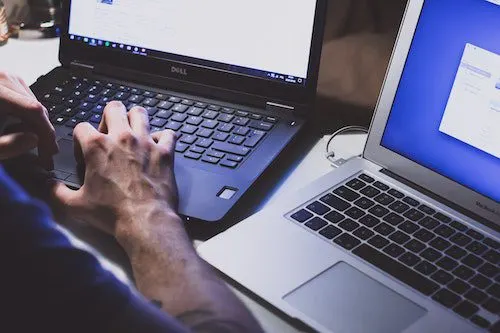 Security specialist working at computer monitors